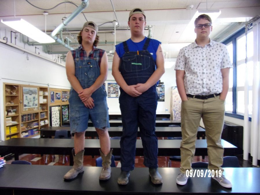 Brennen Burkett, August Biernbaum, and Nathan White dress for Country vs. Country Club on Monday.