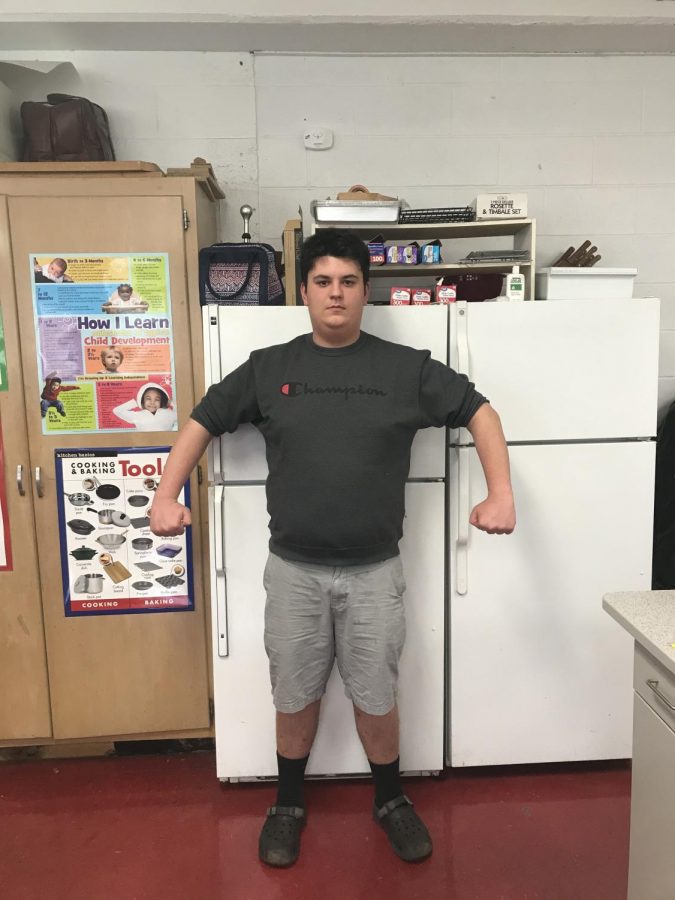 Want food? You cant have any. Struggling to look manly, August Biernbaum does the only thing he knows how: stands in front of the fridge and poses like a strong man. Author and Editor Nathan White asked me to do a pose after an interview, I had to do something great. This is the result. Nathan said of the event, I think you were asserting dominance, it made me feel very small.