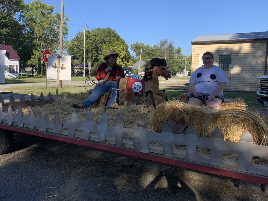 Seniors Destinee Mahlmeister and Abbeye Murdock pose aboard the senior class float.  The float received fourth place in the float competition.