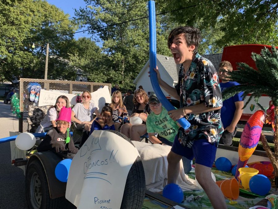 Alix Bennett strikes an enthusiastic pose for the freshmen class float.  The float received third place in the float competition.