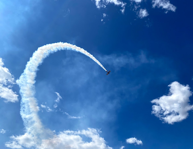 The Crawford County Airport presents: Wings By The Wabash.  Pictured is an airplane performing.