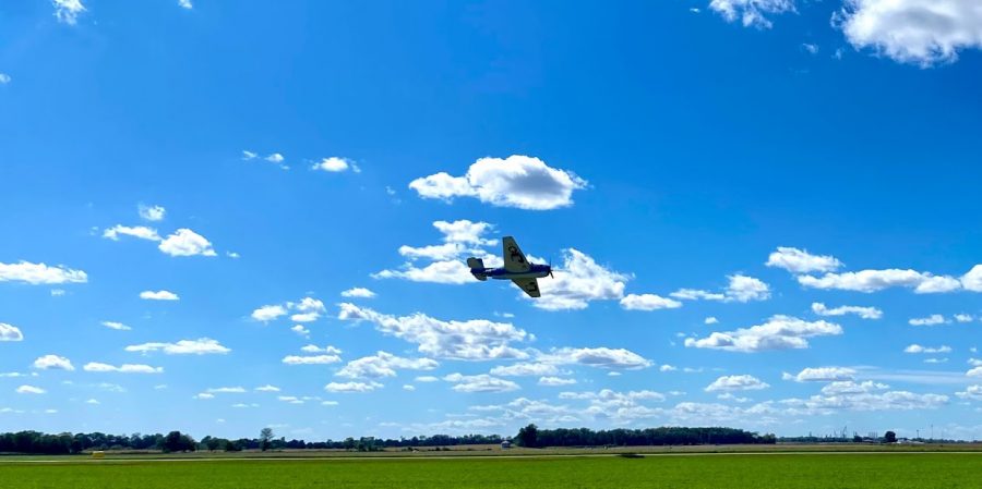 The Crawford County Airport presents: Wings By The Wabash.  Pictured is an airplane performing.