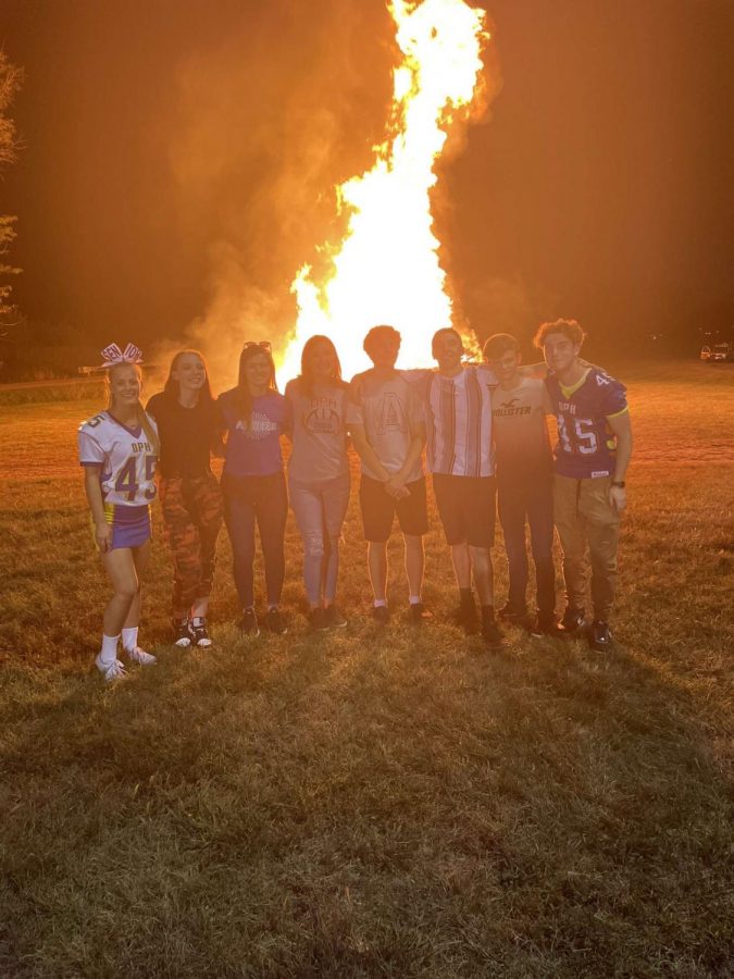 PHS seniors pose in front of the bonfire after the Homecoming Parade Wednesday night.  The Homecoming bonfire has been a PHS tradition for many years.