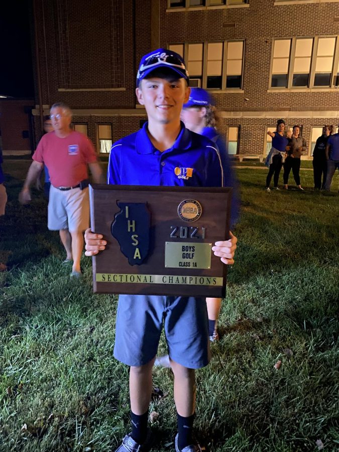 Cody York holds the Sectional Championship trophy.   The boys OPH golf team won Sectionals on Monday, October 4.