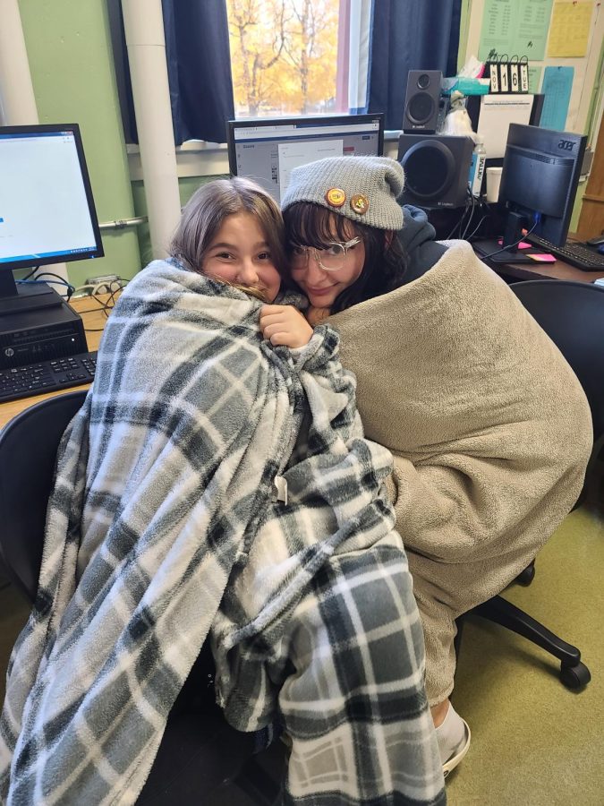 Micheala Fuller and Zoey Rhinesmith staying warm in Ms. Huffingtons. 