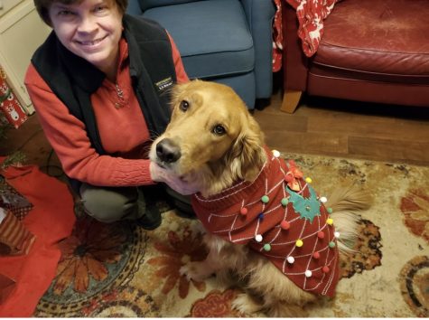 Mrs. Hyde and her dog Buster dressed in his Christmas sweater. 