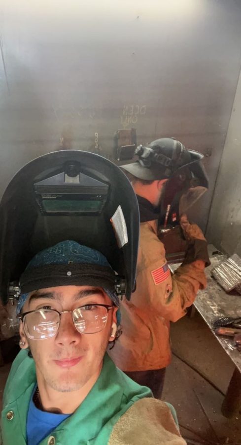 Elliott posing while welding