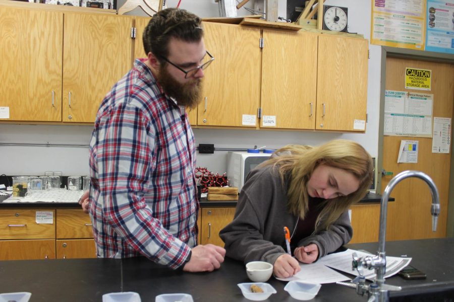 Teacher helping student with the lab 