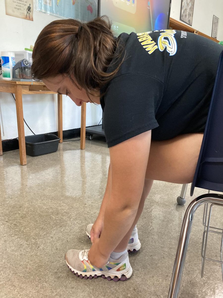 Haley Murdock tying her shoes