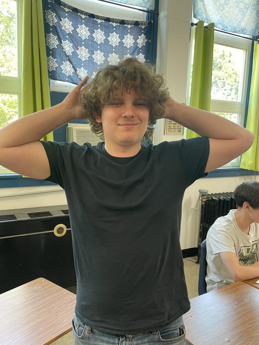 Preston Nidey showing off his luscious curly hair in Journalism class.  