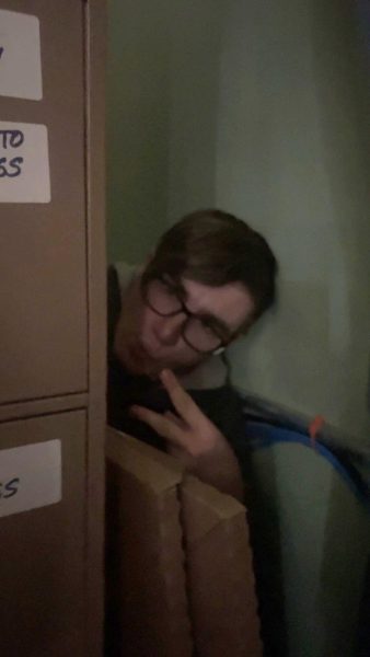 Justin Fuller hides behind a filing cabinet in Mrs. Baileys room during the recent Active Shooter Drill.
