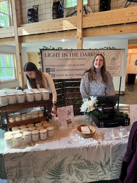 Autumn Taylor at her CEO booth, with her sister Adriana helping.