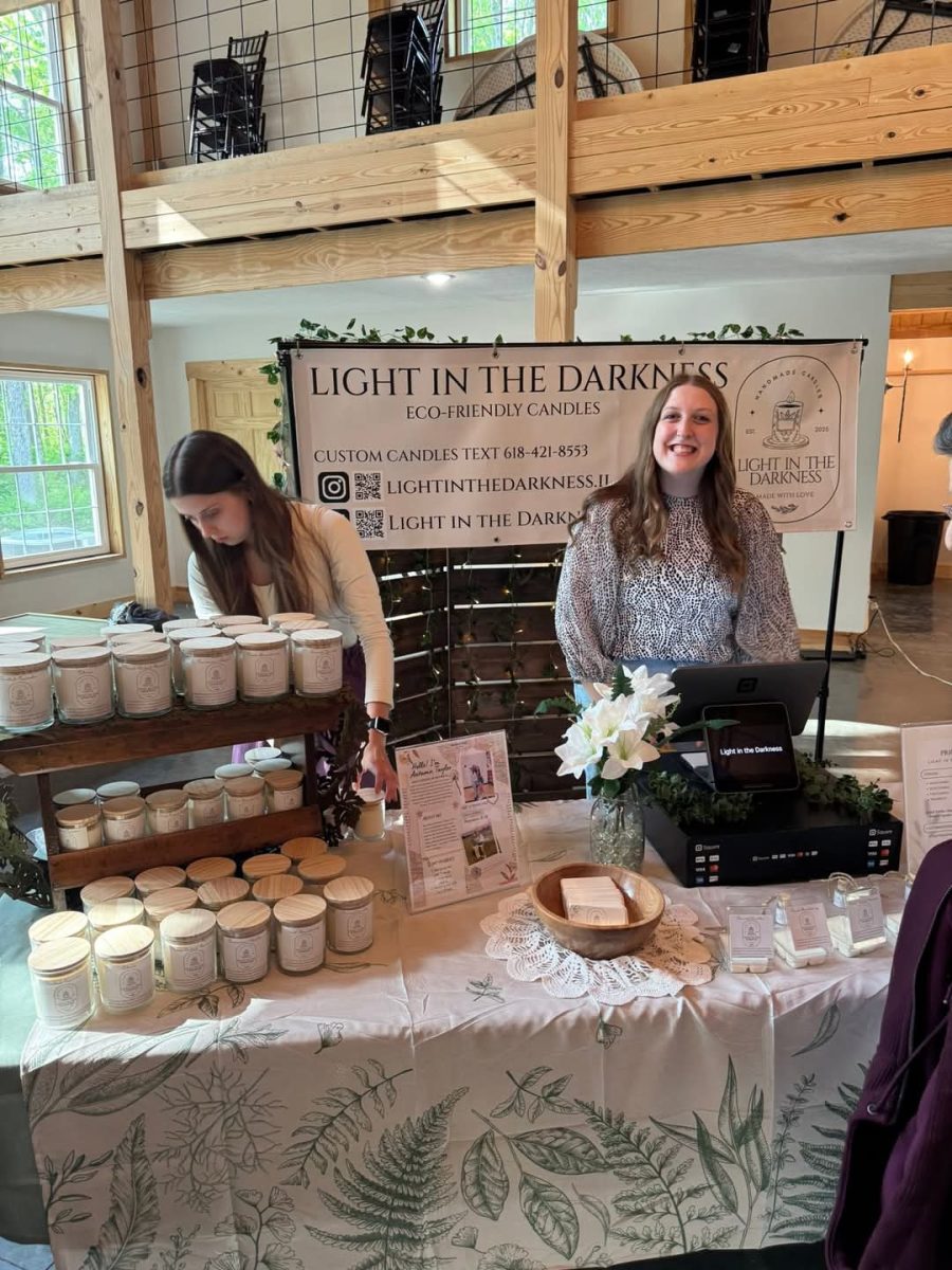 Autumn Taylor at her CEO booth, with her sister Adriana helping.